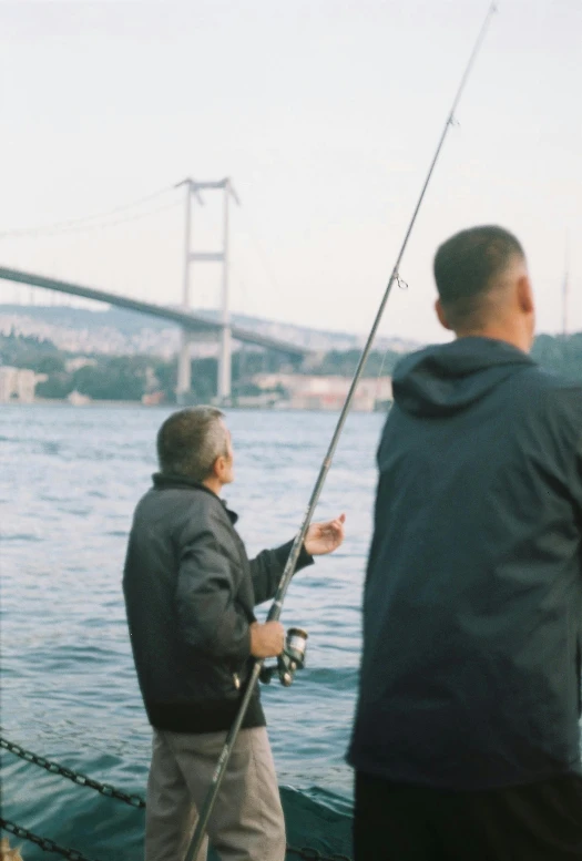 two men who are fishing on some water