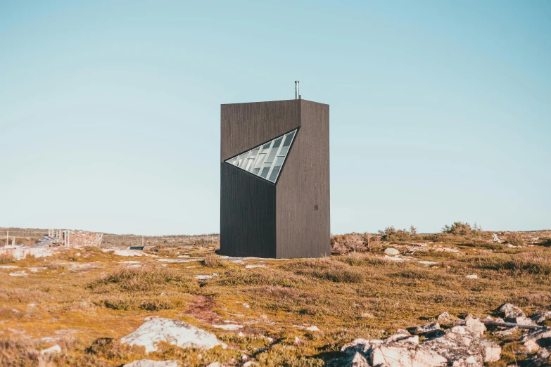 a tall black tower with a large triangular design