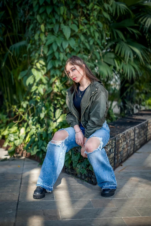 a woman in black top and jeans posing for a picture