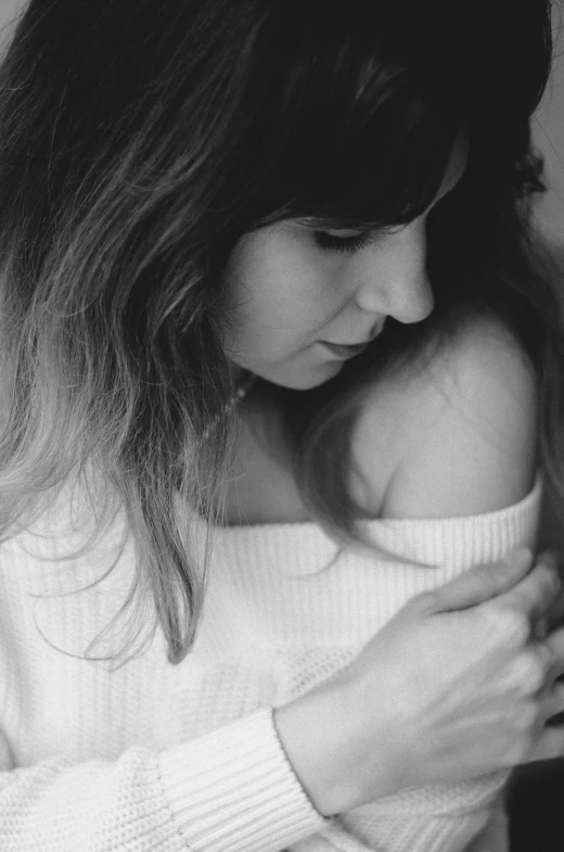 woman holding and looking down at her 