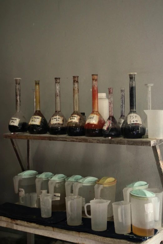 various bottles and containers lined up on a shelf