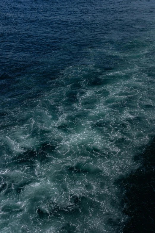 a boat sailing in the middle of a body of water