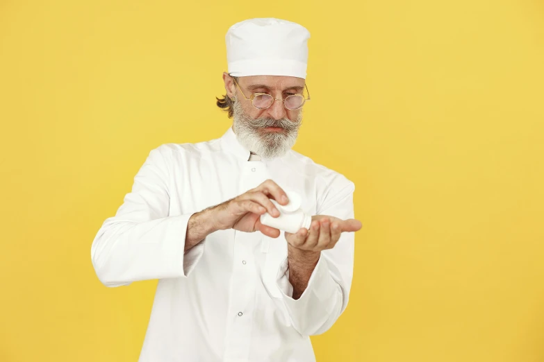 a man wearing an white hat and robe is pointing out