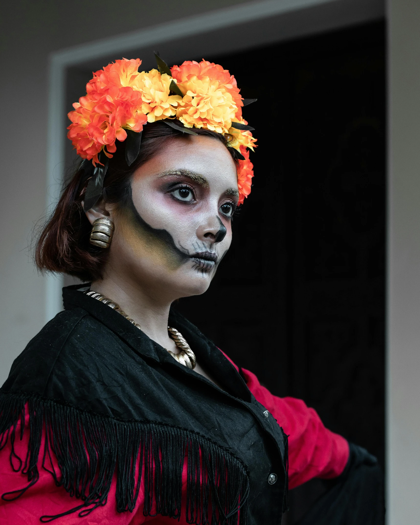 a girl with day of the dead makeup and headdress