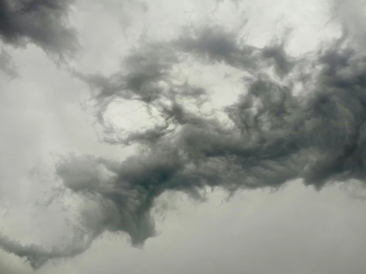 smoke trails from an airplane on a cloudy day