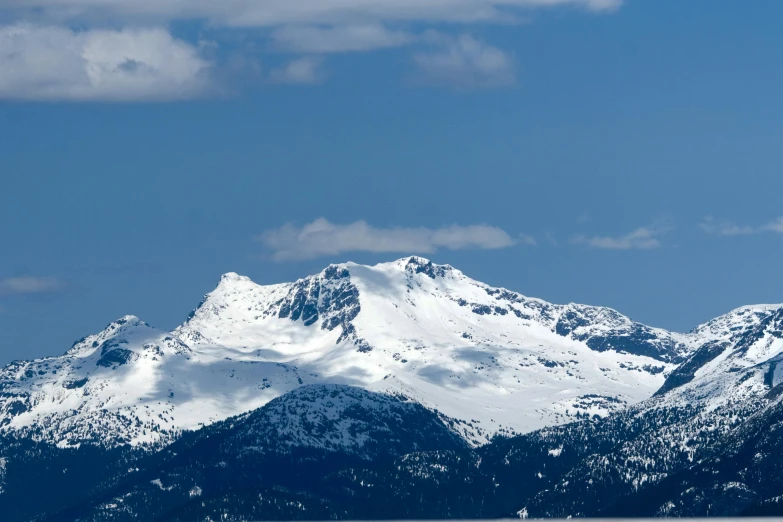 two very tall snowy mountains with snow on them