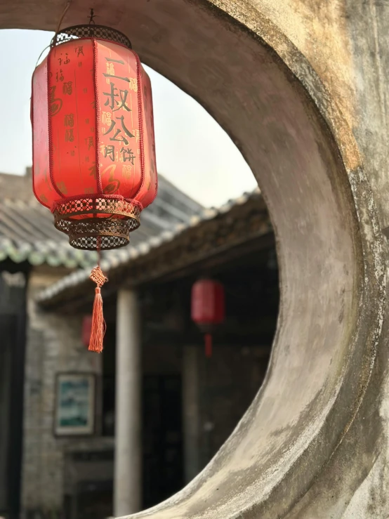an oriental lantern suspended from the side of a building