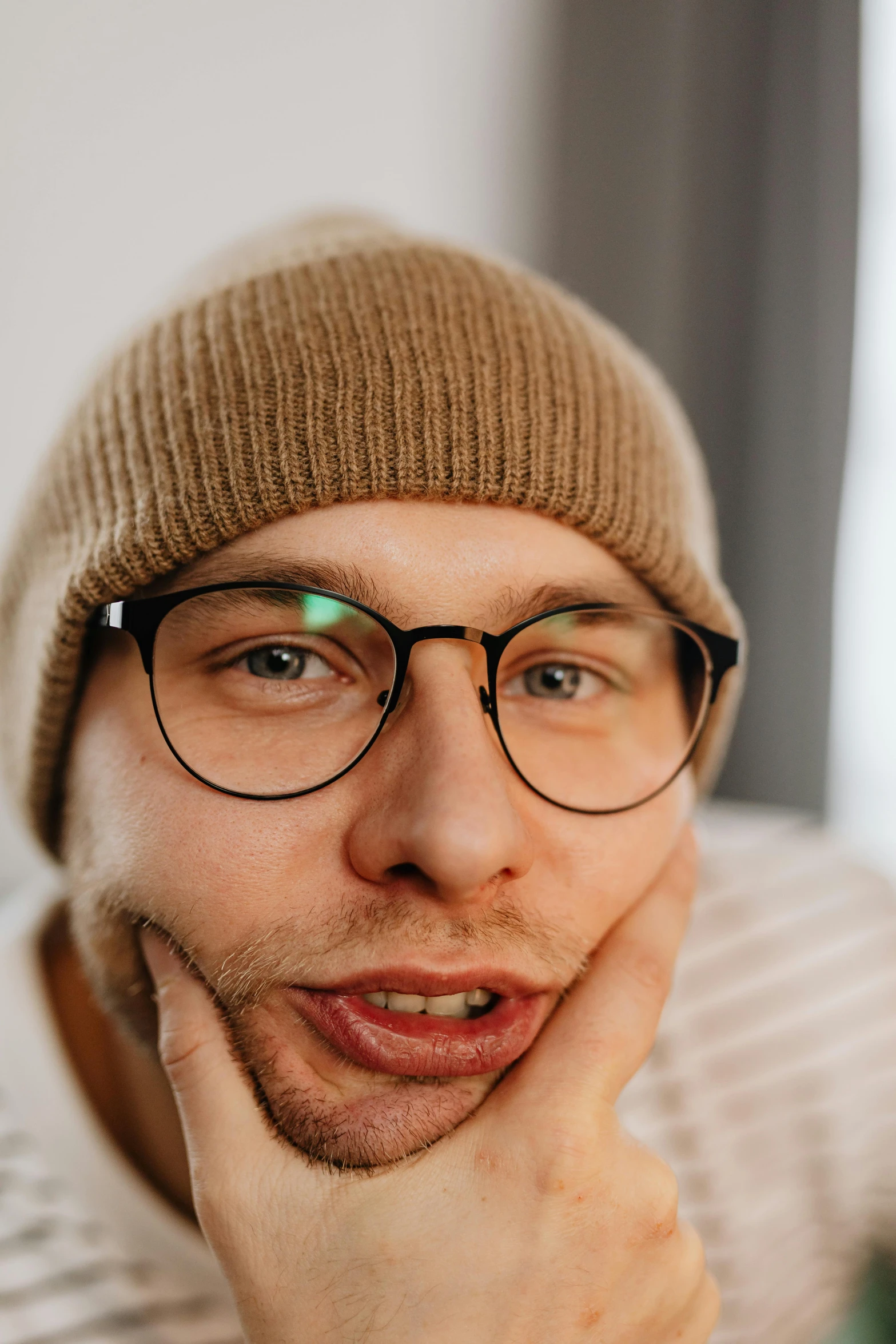 a man with a beard wearing a hat and glasses