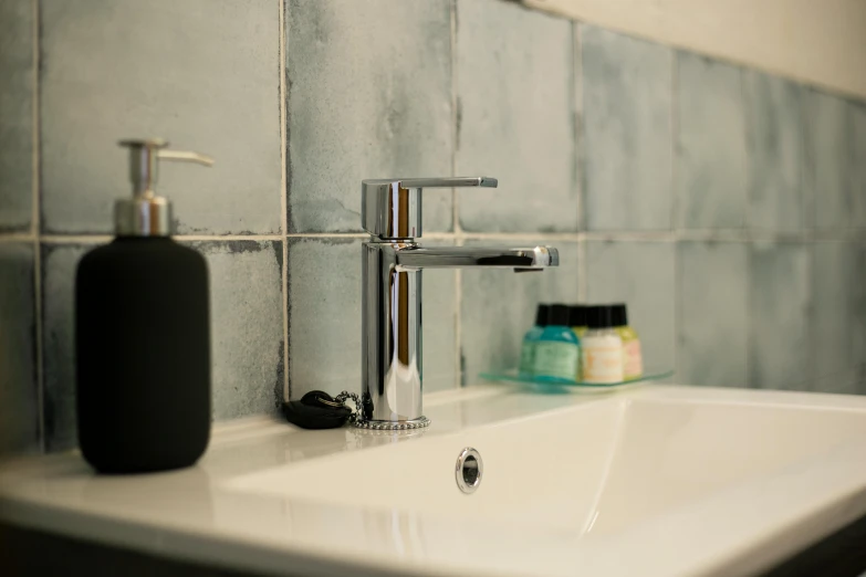 a sink with soap and other bathroom items