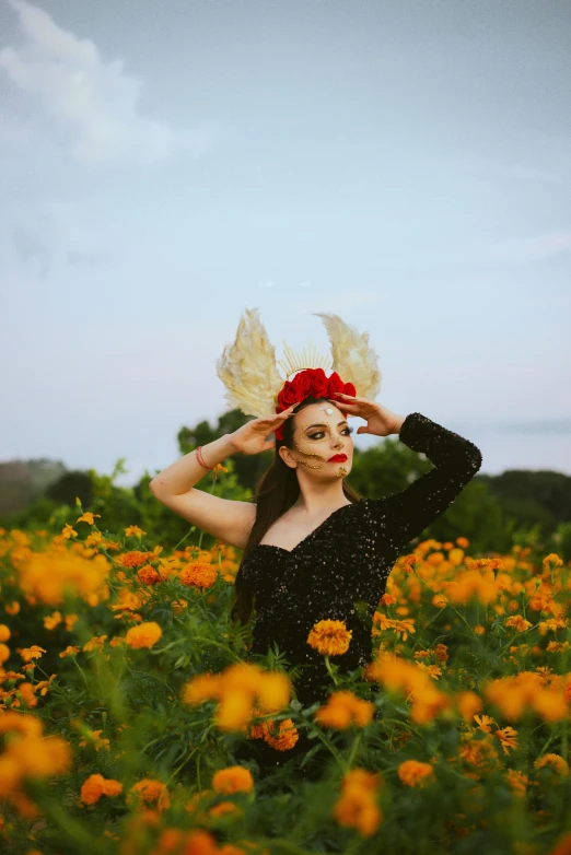 a woman with a wreath in her hair standing in flowers