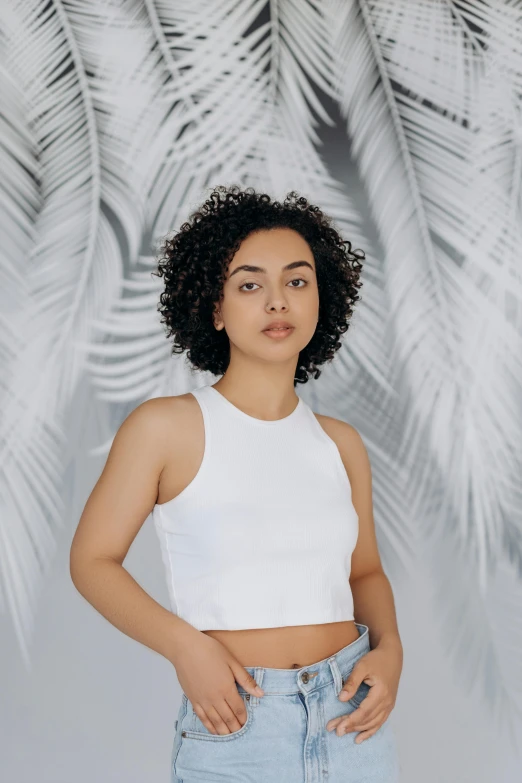 a young woman in jeans and a crop top