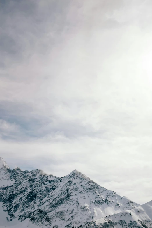 two skiers skiing on a snow covered mountain slope