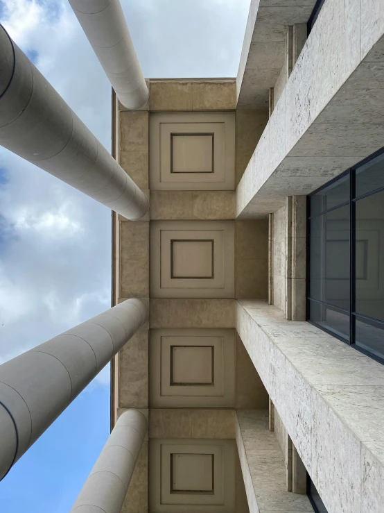 the view from inside a building looking at pipes