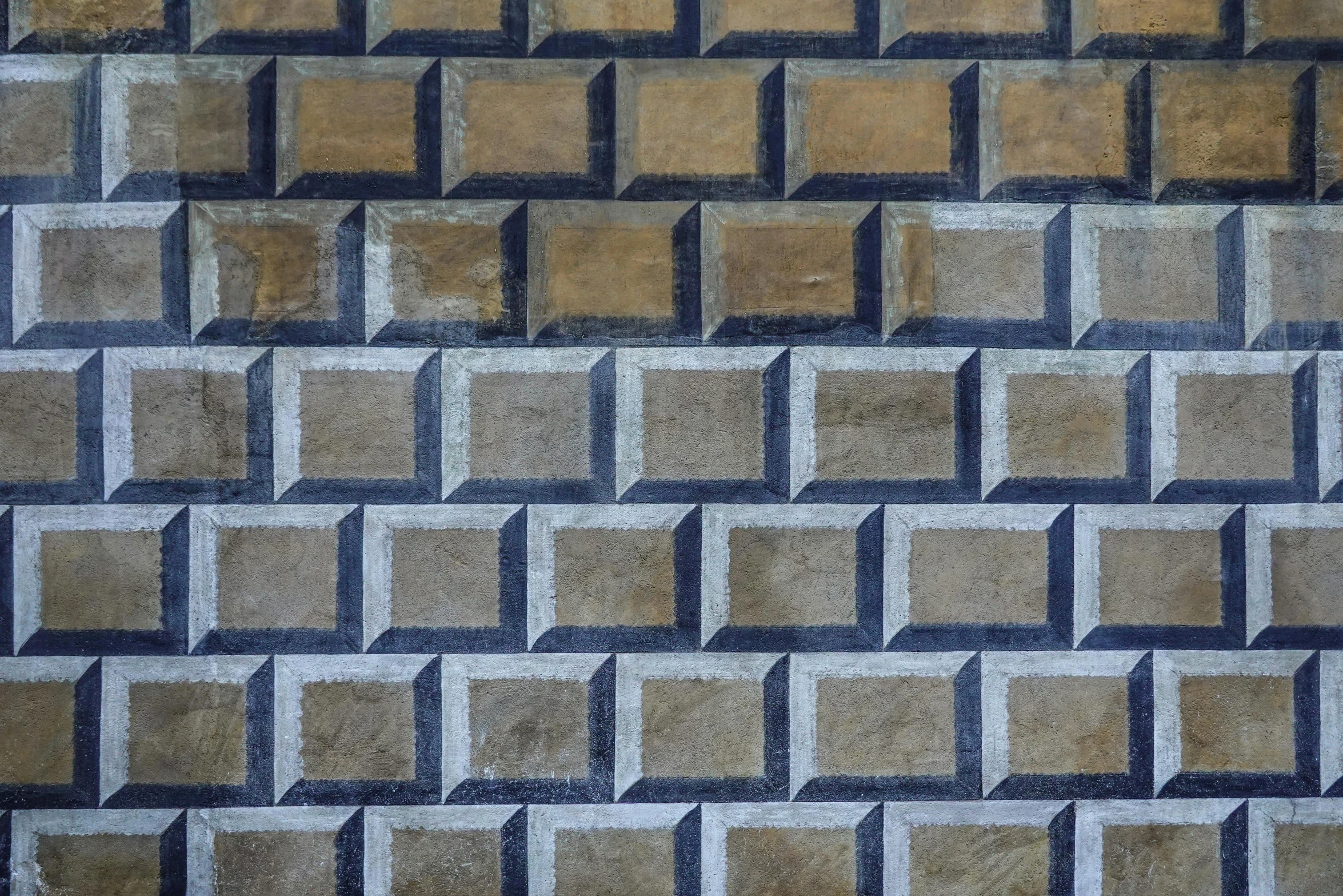 a textured wall with blocks pattern made up of various color and shapes