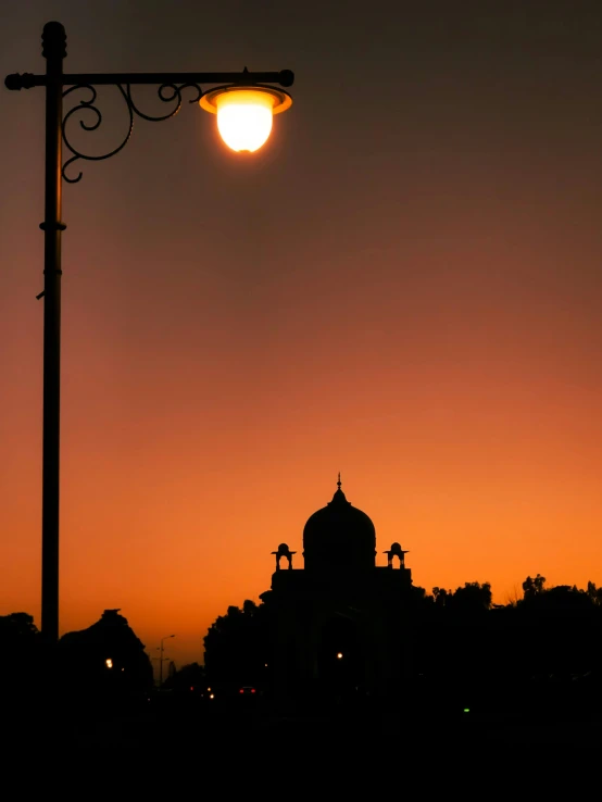 a street light next to a building and clock tower