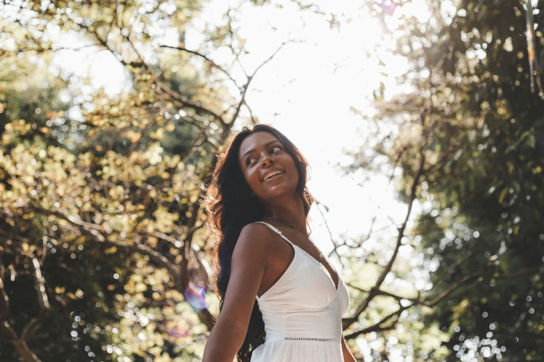 a woman is posing with a smile for the camera