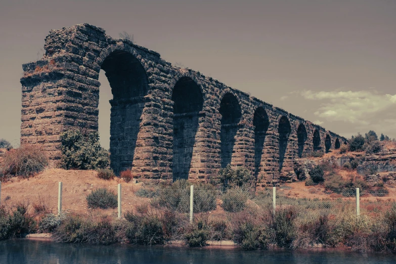 an old brick bridge sits near the water