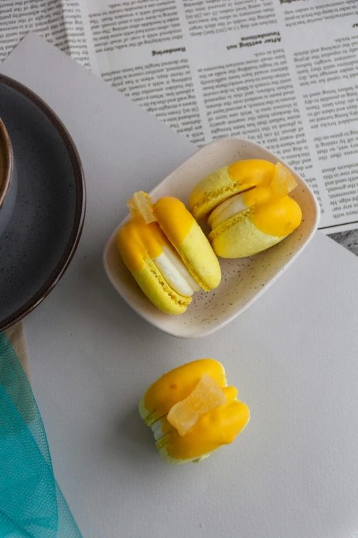 a tray topped with mini fruit pieces next to a mug