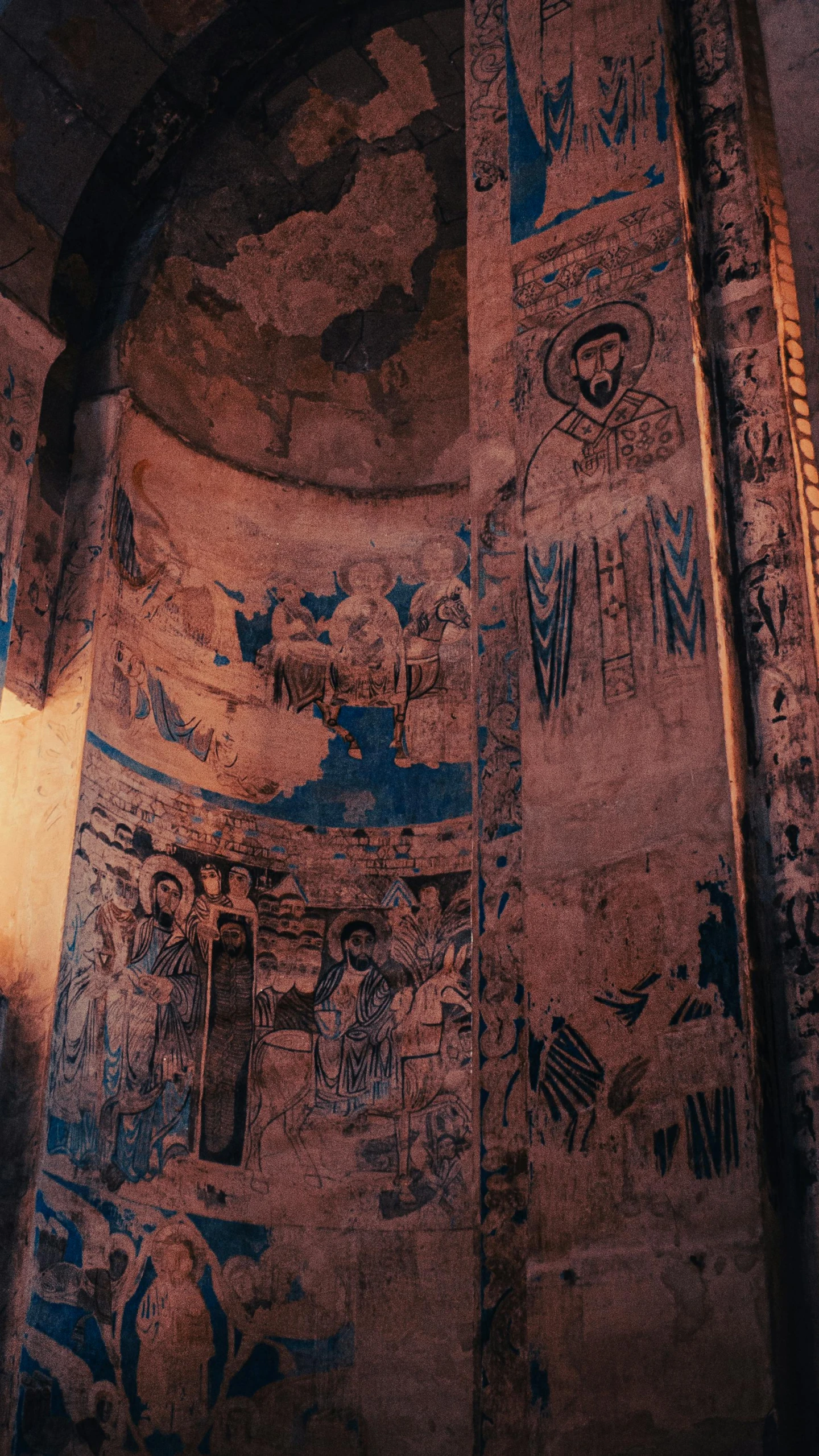 a clock in a tower with some drawings on the side