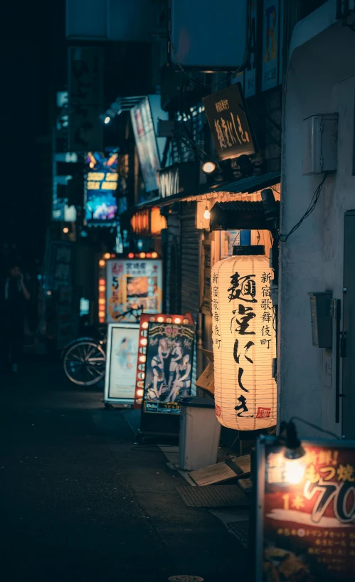 several signs are lit up on the street