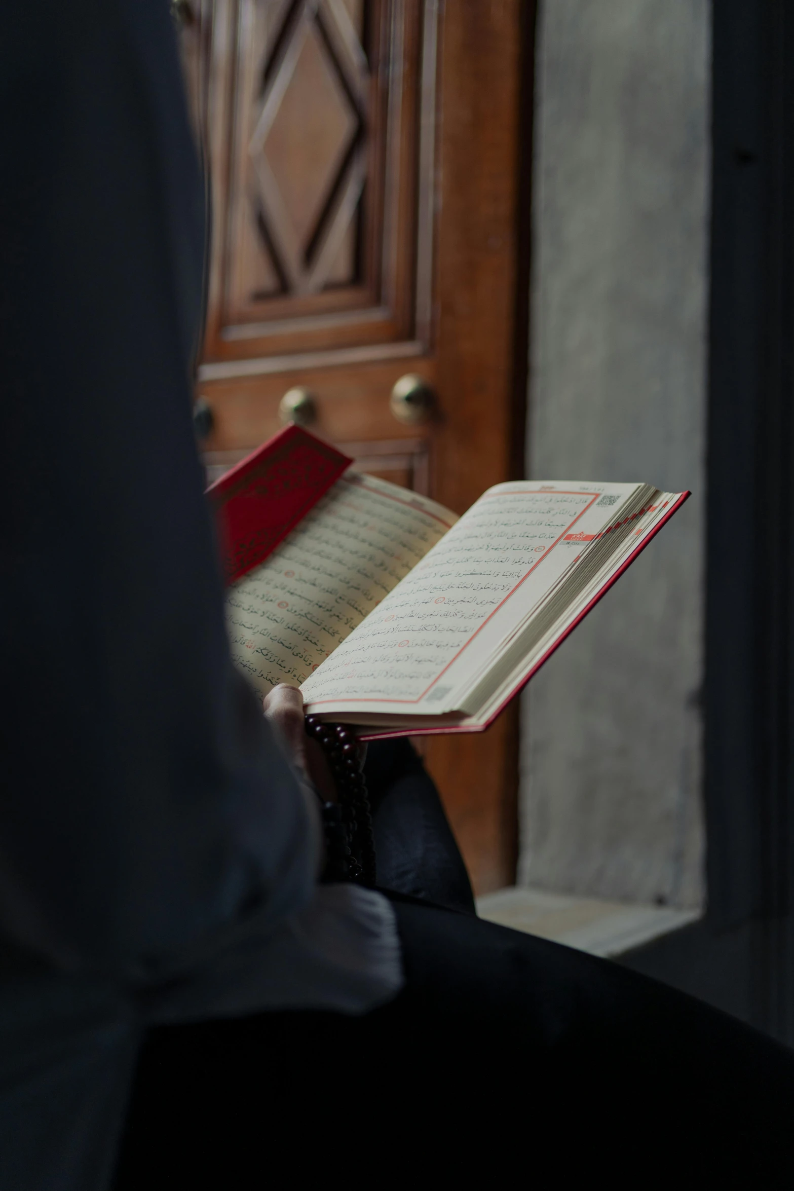 someone is sitting with their book and the door opened