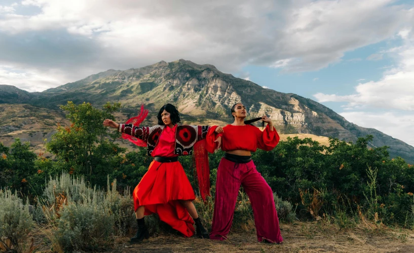 two women dressed in red dancing outdoors