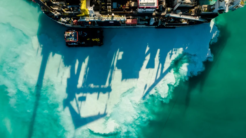 an aerial view of a ship on a body of water