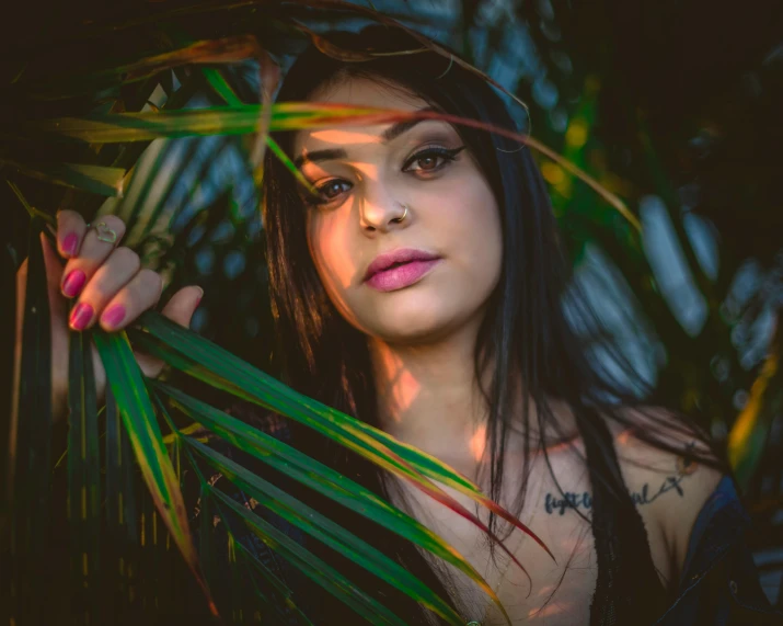 a woman with a green plant in her hand