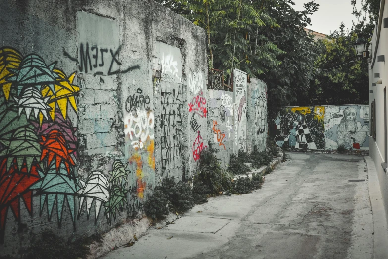 an image of a concrete wall covered with graffiti