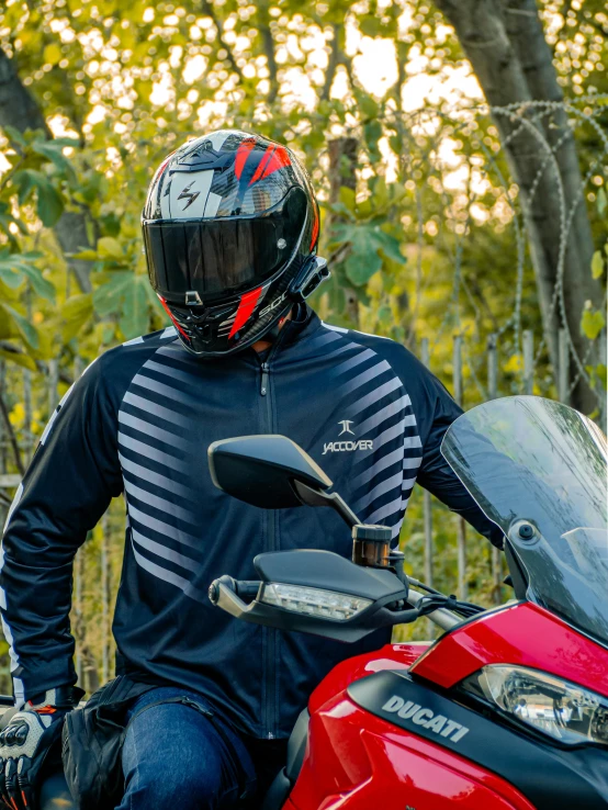 a man wearing a helmet and sitting on a motor bike