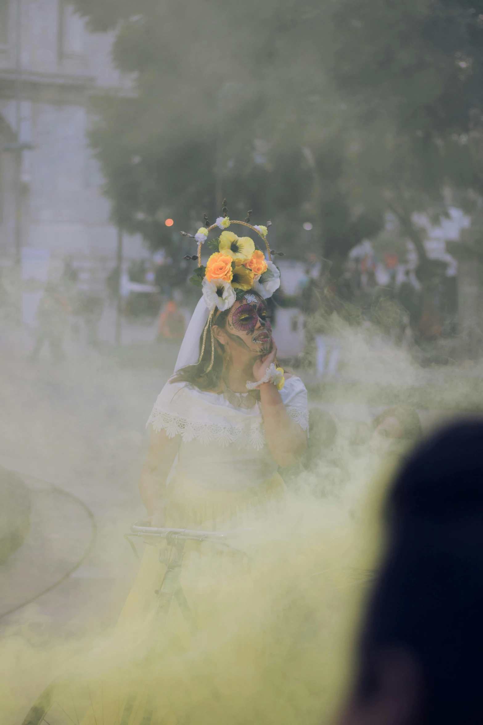 a woman in a white and yellow dress on her cell phone