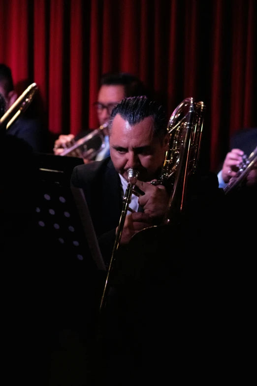 a conductor and his band are playing in a orchestra