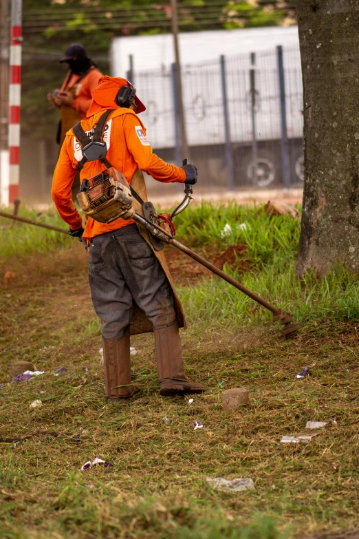 a person is walking with a chainsaw near a tree