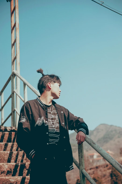 a man standing on a staircase in front of mountains