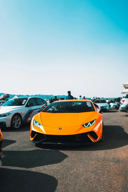 three yellow sports cars are parked next to each other