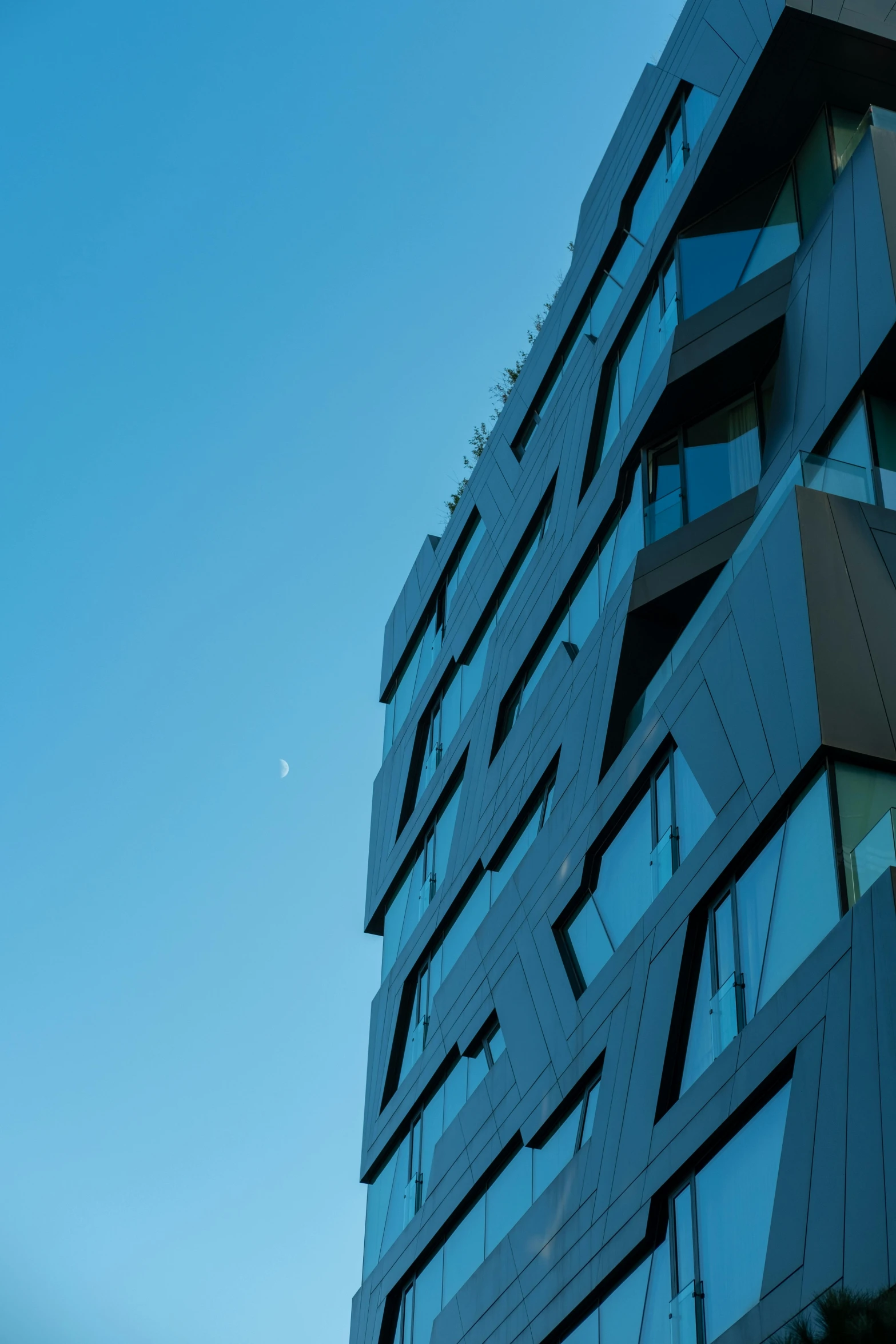 the building is very tall with the curved windows