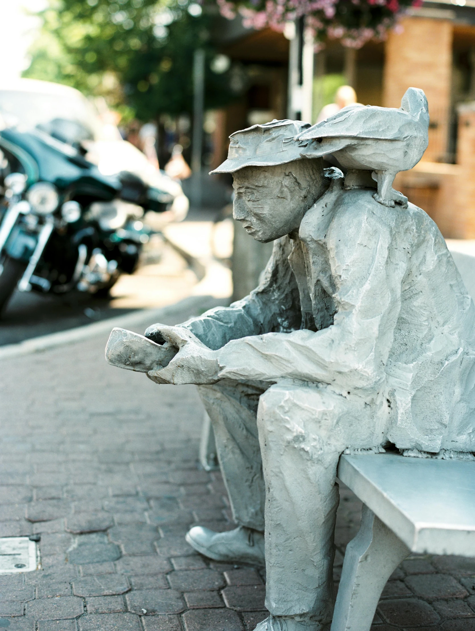 the statue is sitting on the bench, with the other part visible