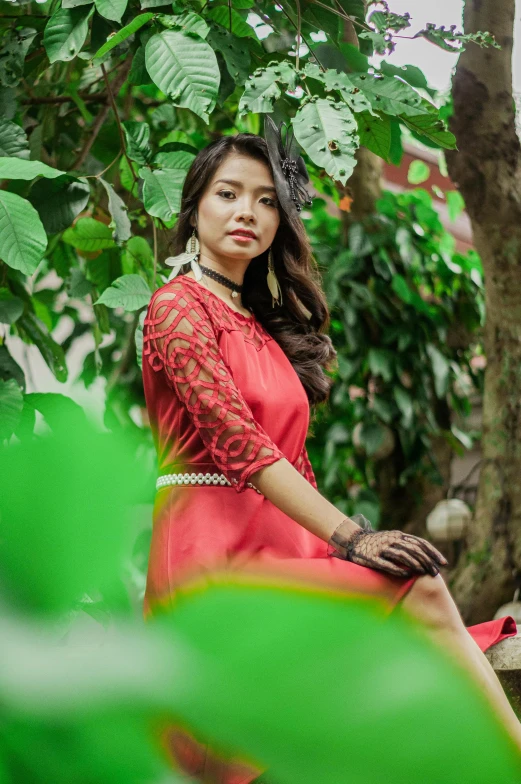 a girl sitting on a green chair outside