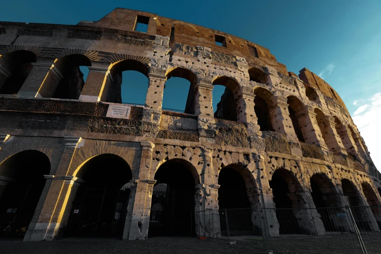 a large old roman structure standing against a blue sky