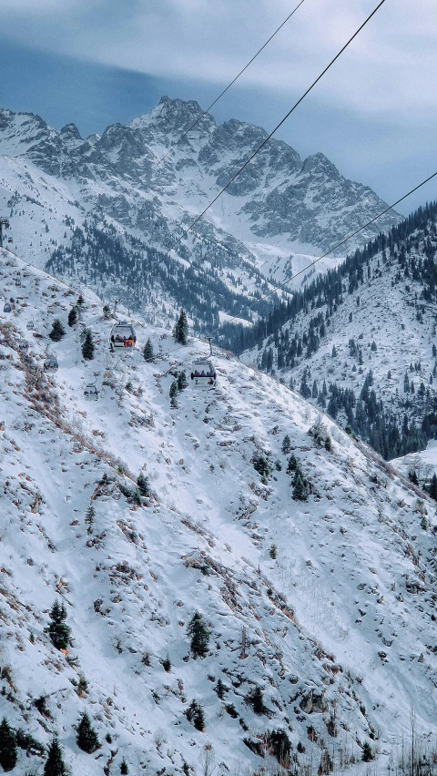 a snow covered mountain with a telephone wire and wire