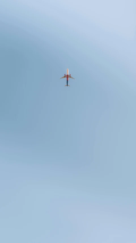 two people standing on a roof and a plane flying in the sky