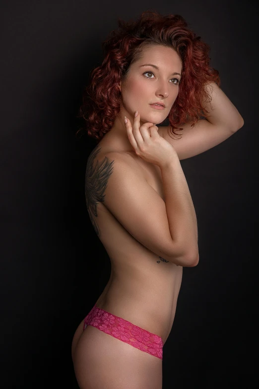 a beautiful young red haired woman in pink panties