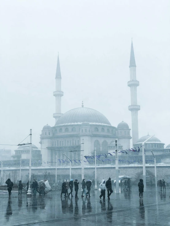 a group of people are outside in the rain