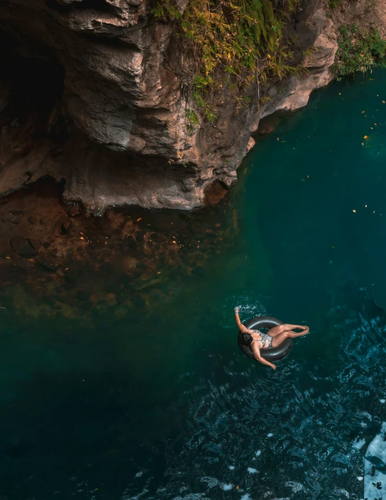 aerial view of a woman swimming in a stream