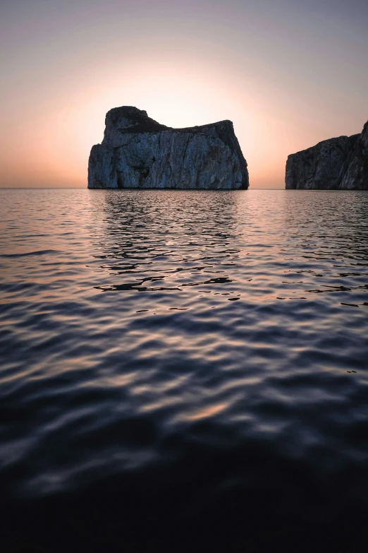 a rocky island in the middle of the ocean