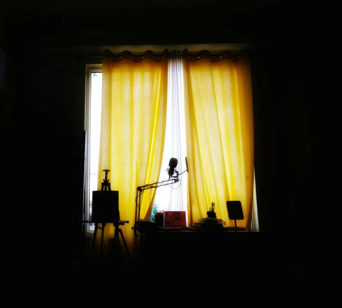 the light is shining on a yellow curtain