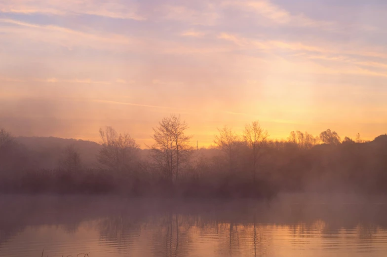 the view of the sunset over a lake