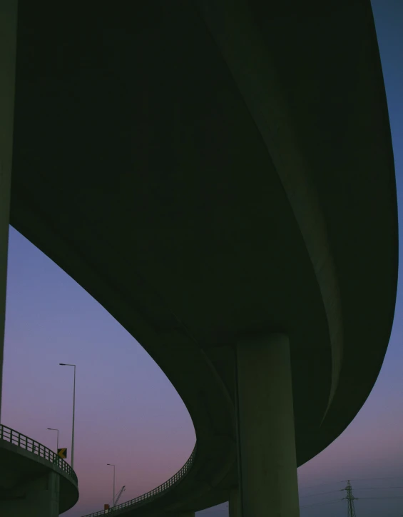 a building and tower are near two traffic lights