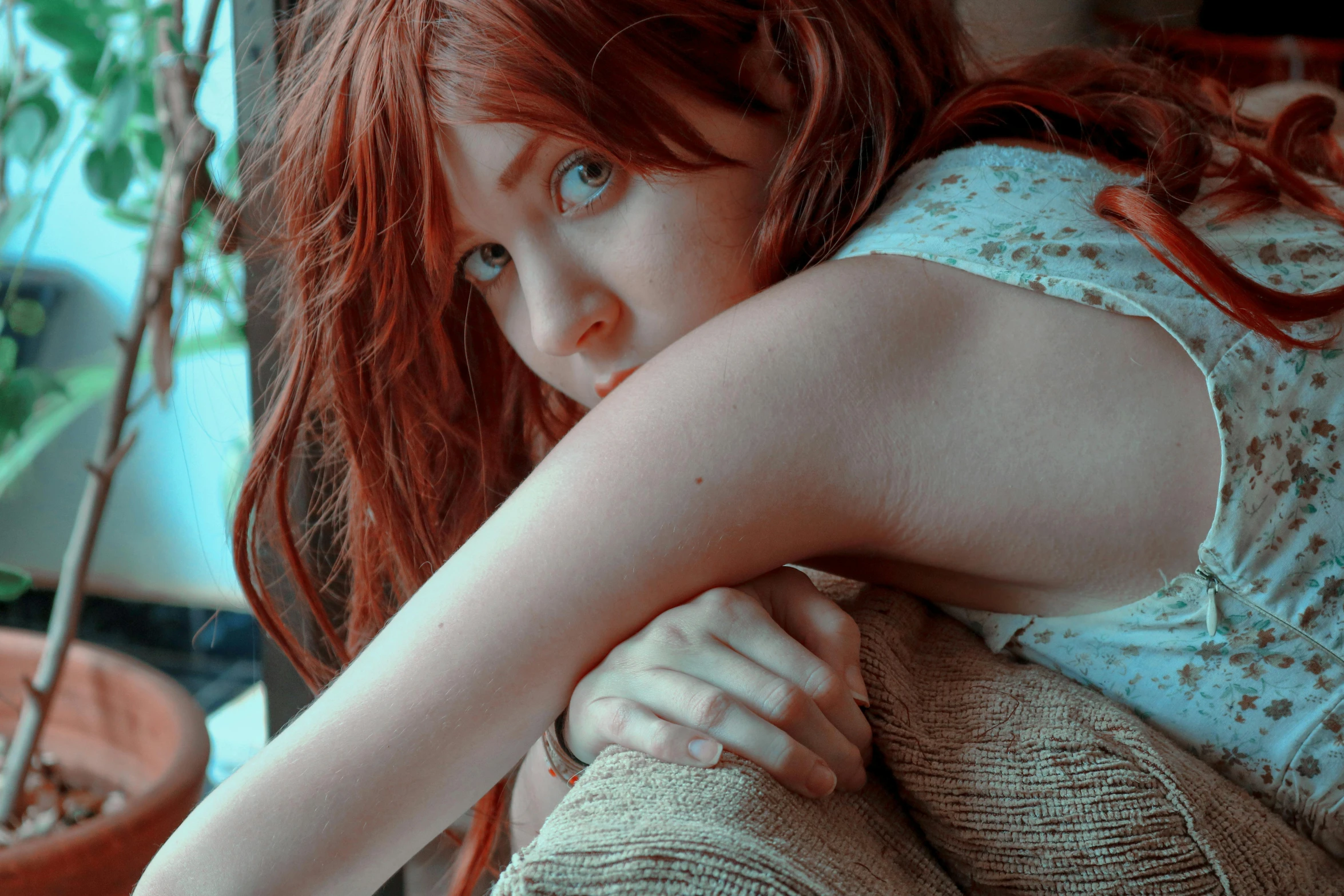 a woman with red hair looking away from the camera