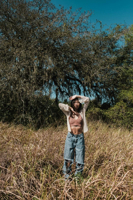 a shirtless man in the middle of a field